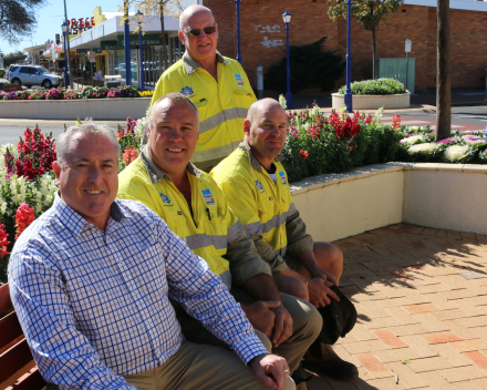 Sitting in one of the flower-filled spaces they’ve created are: (L to R) Matthew Robertson (Parks and Open Space Coordinator), Harry Mager (Parks and Open Space Ganger), Craig Lewington(Parks and Open Space Ganger) and standing, Kevin Sheppard (Parks and Open Space Supervisor).